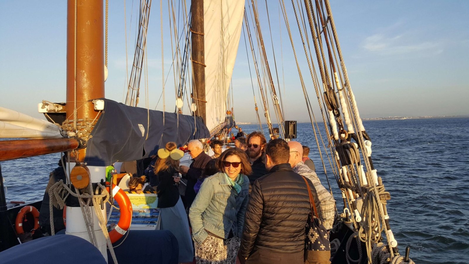 People socializing aboard a sailboat