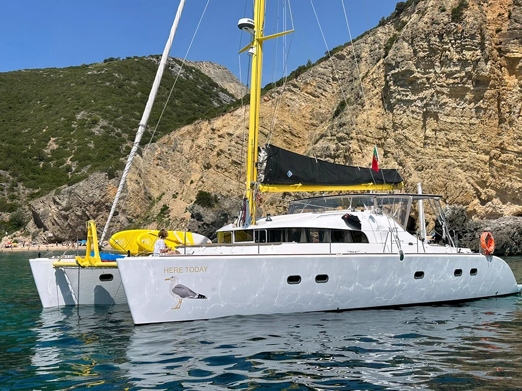 Catamaran anchored off the Arrábida Mountains