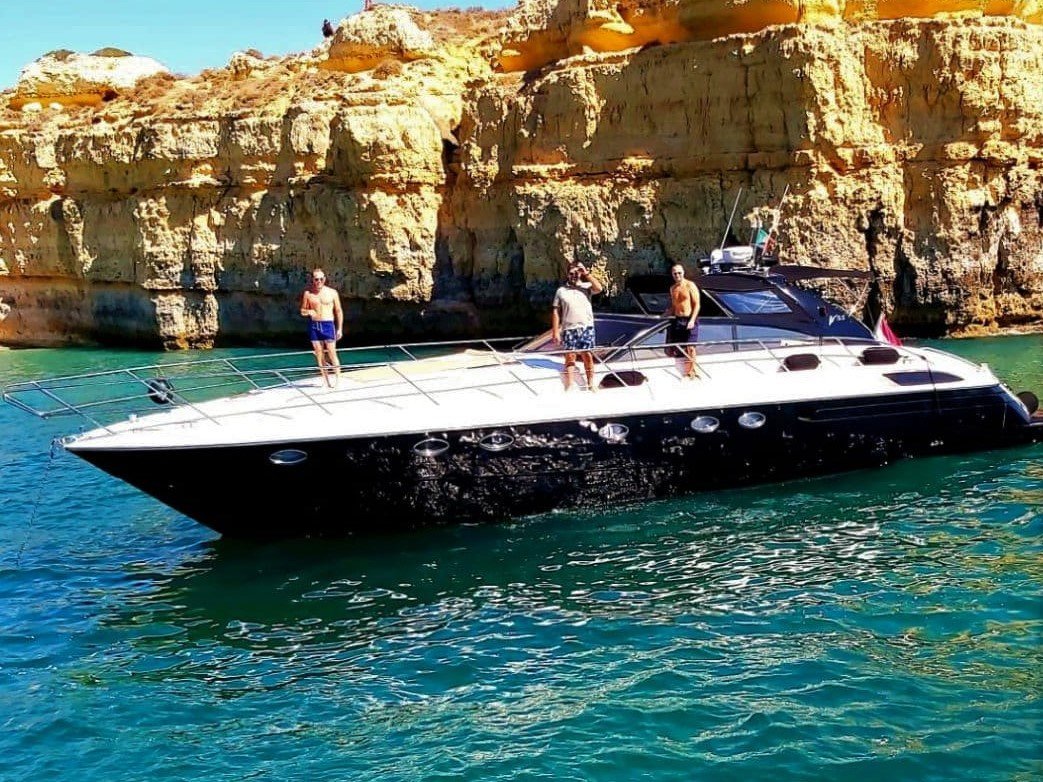 The Princess V55 cruising along the Algarve coast—perfect for exploring beaches, caves, and coves on a private charter departing from Vilamoura.